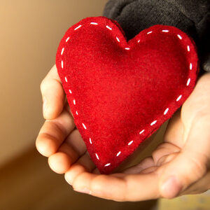 33237834 - red heart in child hands, gift, hand made valentine, close up, horizontal